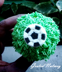 Cupcake covered with Buttercream Frosting. The football is made of royal icing.