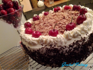 Black Forest Cake Covered with Whipped Cream and Shaved Chocolate