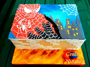 Spiderman Themed Cake. Webs on Spiderman's costume and on the top right corner of the cake made with Royal Icing.