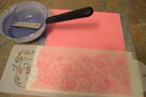 Place a stencil on it and use royal icing to make the design.