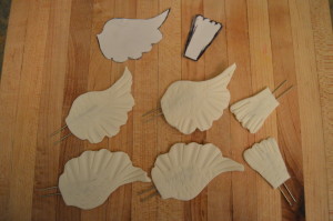 Make wings and tails. Draw or print out templates from the net. Cut out fondant using the templates and insert floral wires into both the wings and tails. Leave these to dry thoroughly. 